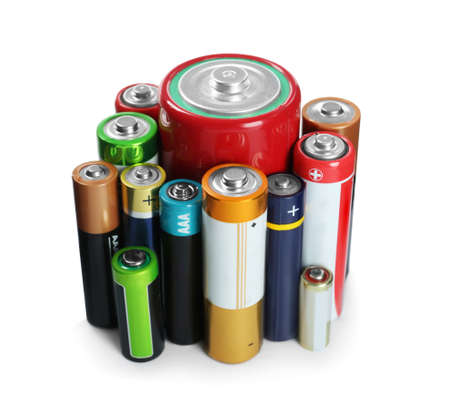 Many batteries of different types on white backgroundの写真素材