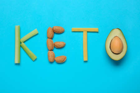 Word Keto made with different products on light blue background, flat layの写真素材