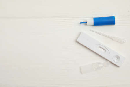Disposable express hepatitis test kit on white wooden table, flat lay. Space for textの写真素材