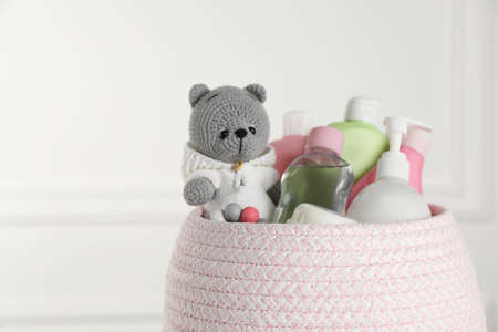 Basket full of different baby cosmetic products and toy on blurred background, closeupの写真素材