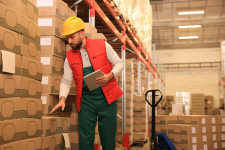 Man with tablet working at warehouse. Logistics centerの写真素材