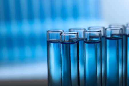Test tubes with reagents on blurred background, closeup. laboratory analysisの写真素材