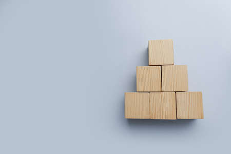 Blank wooden cubes on light background, flat lay. Space for textの写真素材