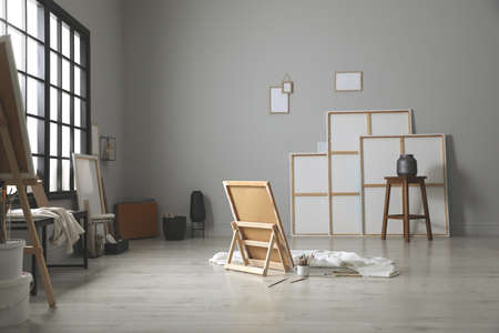 Stylish artist's studio interior with canvas and brushesの写真素材