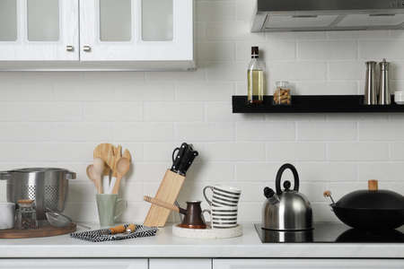 Countertop with different cooking utensils in kitchenの写真素材