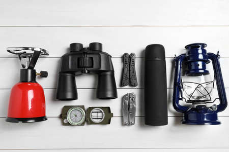 Set of traveler's equipment on white wooden table, flat layの写真素材