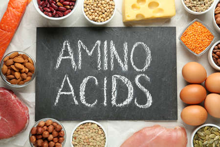 Flat lay composition with products rich in amino acids on light gray tableの写真素材