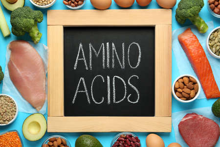 Flat lay composition with products rich in amino acids on light blue backgroundの写真素材