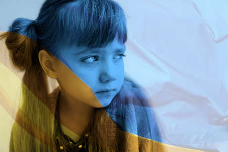 Double exposure of national flag and sad little girl. Stop war in Ukraineの写真素材