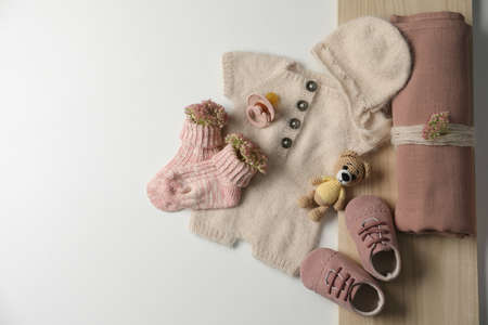 Baby clothes, shoes and accessories on light background, flat lay. Space for textの写真素材