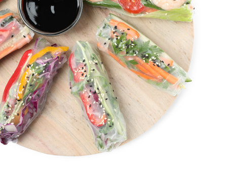 Serving board with delicious rolls wrapped in rice paper and teriyaki sauce on white background, top...