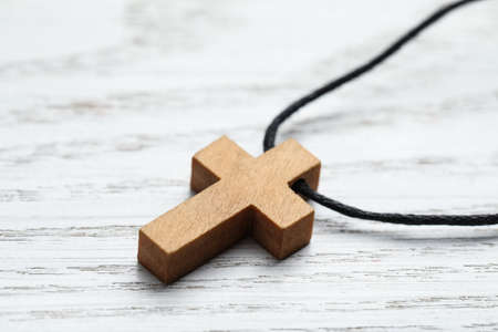 Wooden Christian cross on white table, closeup viewの写真素材