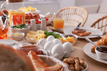 Dishes with different food on table in room. Luxury brunch