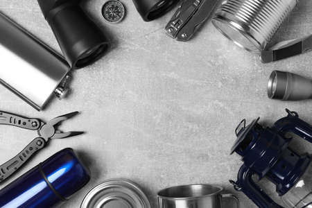 Frame of traveler's equipment on gray table, flat lay. Space for textの写真素材