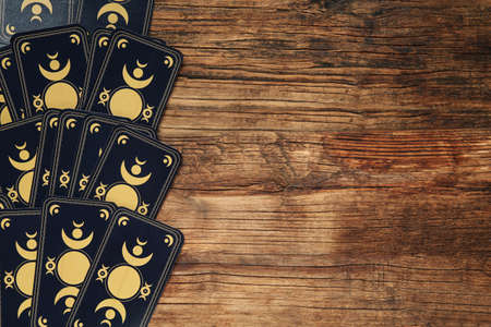 Tarot cards on wooden table, top view and space for text. reverse sideの写真素材