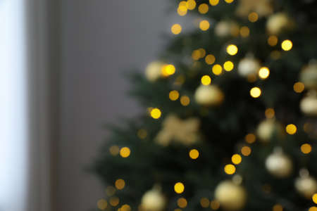 Blurred view of beautifully decorated Christmas tree indoorsの写真素材