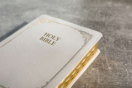 Old hardcover Bible on gray table, closeup. religious bookの写真素材