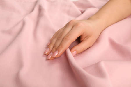 Woman touching soft pink fabric, closeup viewの写真素材