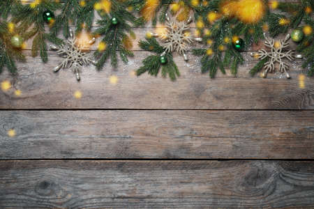 Christmas greeting card with space for text. Flat lay composition of fir tree branches and festive decor on wooden backgroundの写真素材
