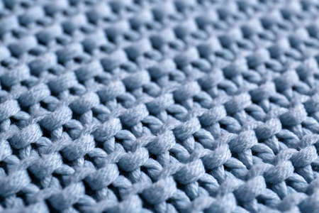 Beautiful light blue knitted fabric as background, closeup