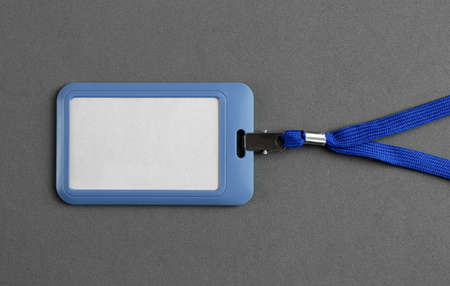 Blank badge on gray background, top view. Mockup for design