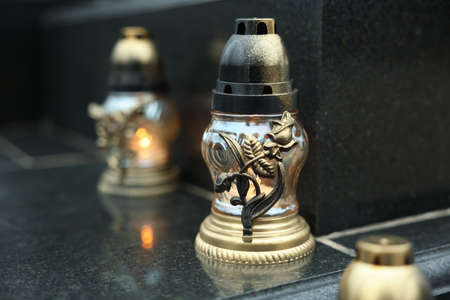 Grave lights on granite surface at cemeteryの販売画像