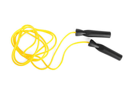 Yellow skipping rope with black handles isolated on white, top view
