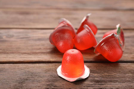 Tasty bright jelly cups on wooden table, space for textの写真素材