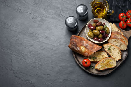 Tasty bruschettas with oil on gray table, flat lay. Space for textの写真素材