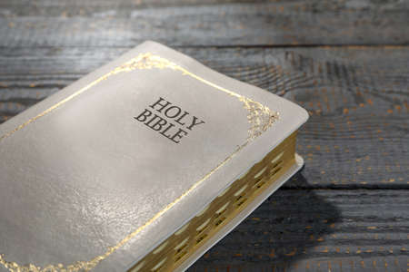 Old hardcover Bible on gray wooden table, closeup. religious bookの写真素材