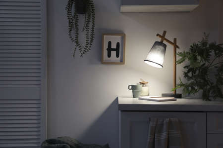 Stylish lamp and decor on white cabinet in room, space for text. interior elementの写真素材