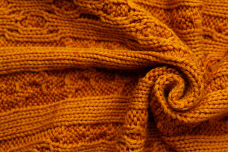 Beautiful orange knitted fabric as background, top viewの写真素材