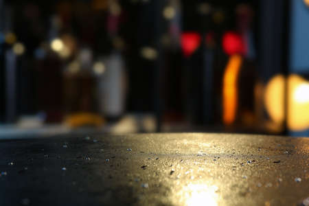 Empty dark gray table with water drops against blurred background, closeup. Space for textの写真素材