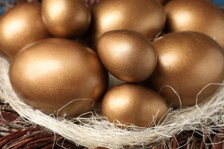 Many shiny golden eggs in nest, closeupの写真素材