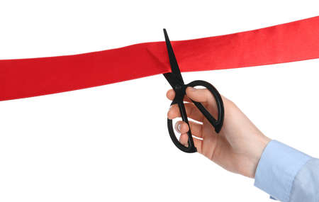 Man cutting red ribbon on white background, closeupの写真素材