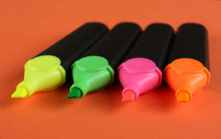 Many colorful markers on orange background, closeup. school stationeryの写真素材