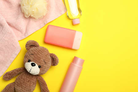 Flat lay composition with baby cosmetic products on yellow background, space for textの写真素材