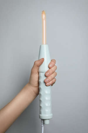 Woman with darsonval on gray background, closeupの写真素材