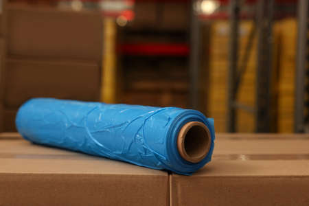 Roll of stretch wrap on boxes in warehouseの写真素材