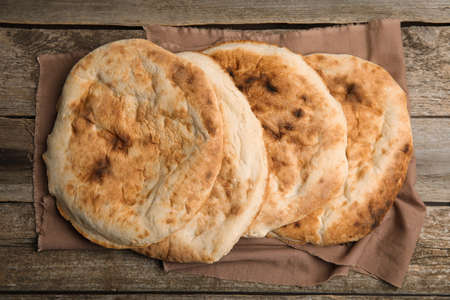 Delicious fresh pita bread on wooden table, top viewの写真素材