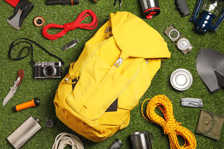 Set of traveler's equipment on green grass, flat layの写真素材