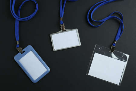Blank badges on black background, flat lay. Mockup for designの写真素材