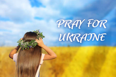 Pray for Ukraine. Double exposure of girl wearing flower wreath outdoors and Ukrainian flagの写真素材