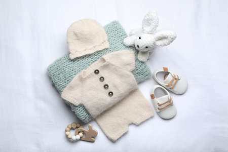 Flat lay composition with child's clothes and accessories on white fabricの写真素材