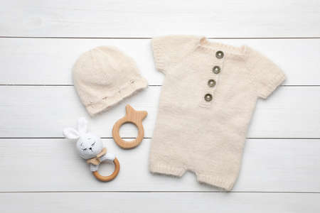 Flat lay composition with child's clothes and accessories on white wooden tableの写真素材