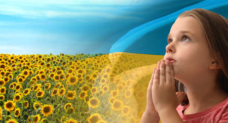 Pray for Ukraine. Little girl against double exposure of sunflower field under sky and Ukrainian flag, banner designの写真素材