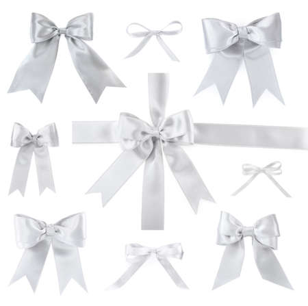 Set with beautiful silver ribbons tied in bows on white backgroundの写真素材