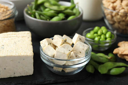 Delicious tofu and other organic soy products on black table, closeupの写真素材