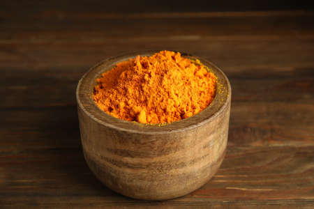 Aromatic saffron powder in bowl on wooden tableの写真素材
