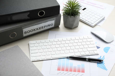 Bookkeeper's workplace with folders and documents on tableの写真素材